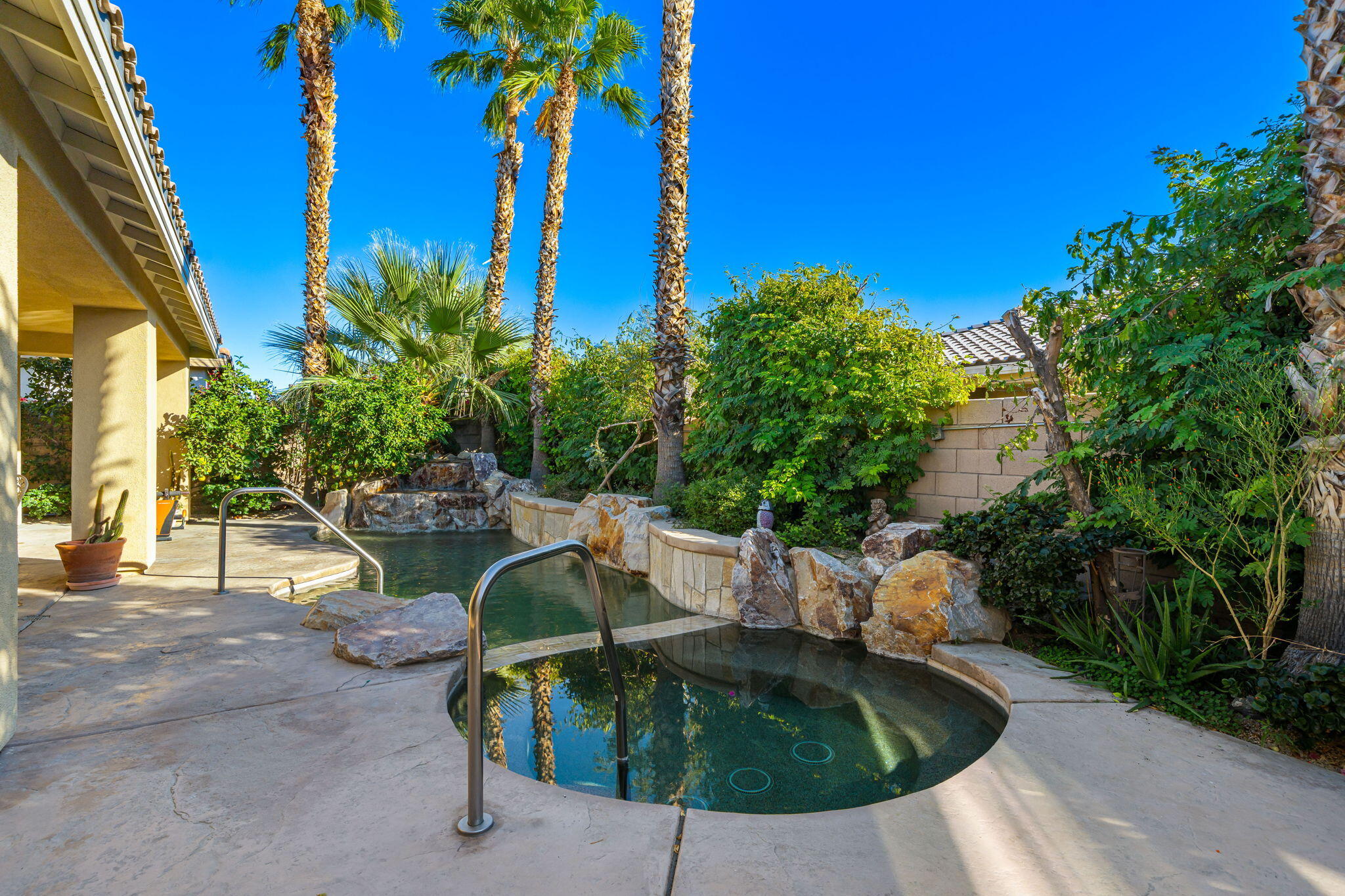 83399 Wagon Road Indio, CA 92203 - Photo 12 of 48 a swimming pool with outdoor seating and plants