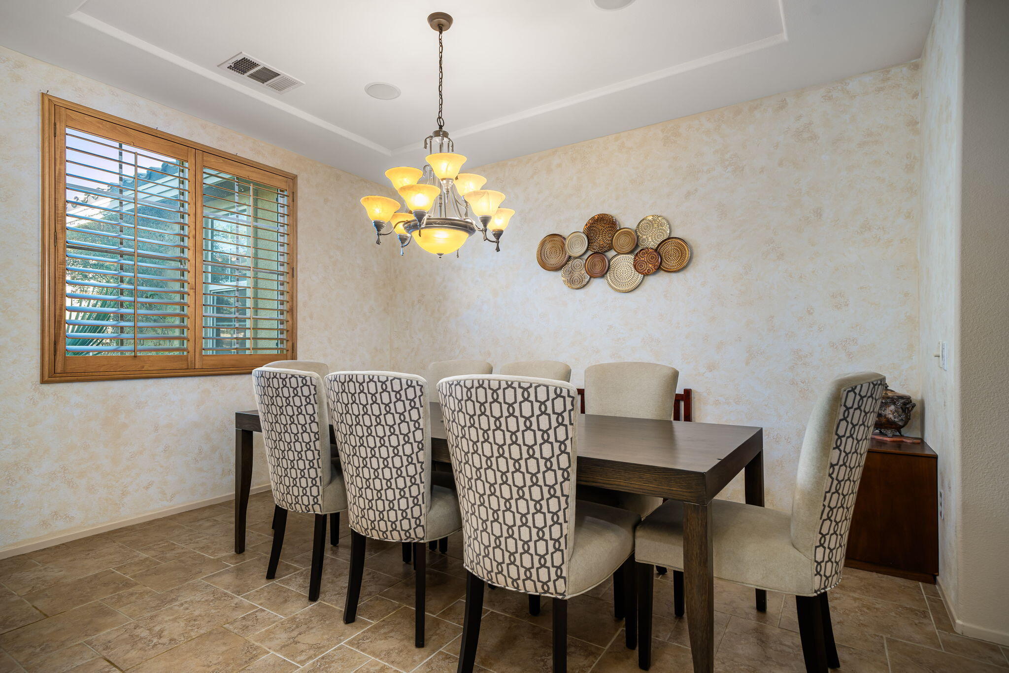 83399 Wagon Road Indio, CA 92203 - Photo 23 of 48 a view of a dining room with furniture wooden floor and a chandelier