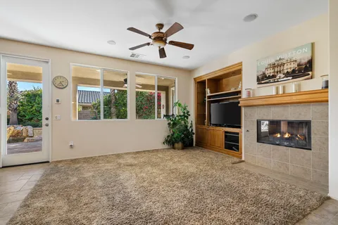 a view of a livingroom with a ceiling fan and window