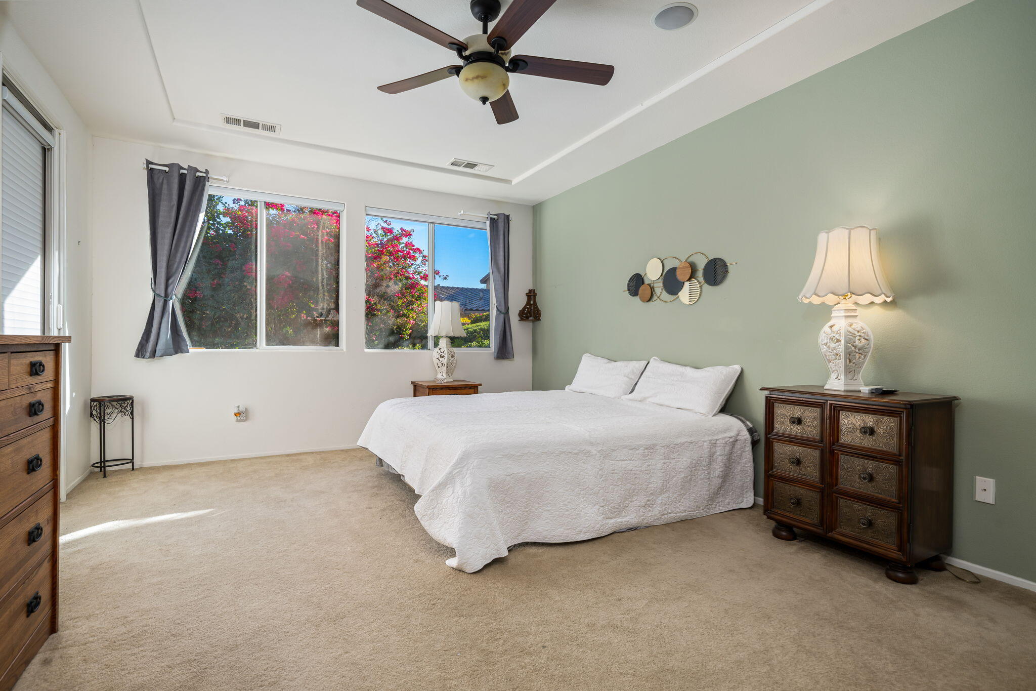83399 Wagon Road Indio, CA 92203 - Photo 31 of 48 a spacious bedroom with a large bed and a chandelier