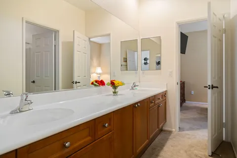 a spacious bathroom with a tub sink shower and mirror