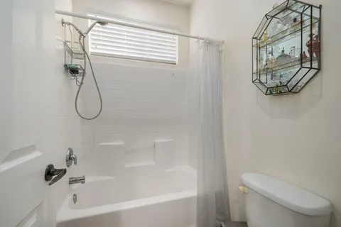 a view of a room with a window and ceiling fan