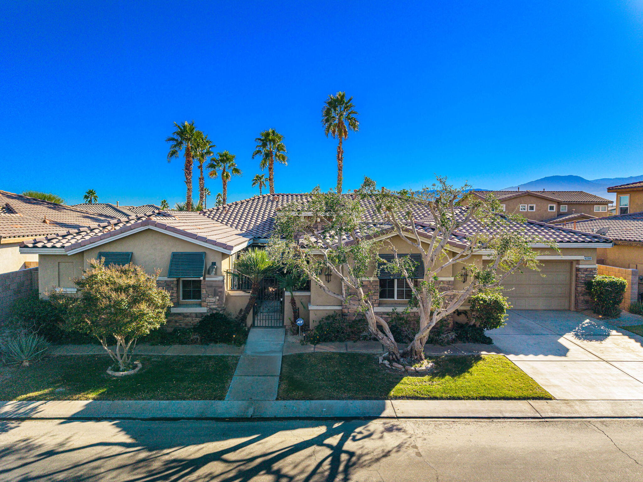 83399 Wagon Road Indio, CA 92203 - Photo 6 of 48 a front view of a house with a yard and potted plants