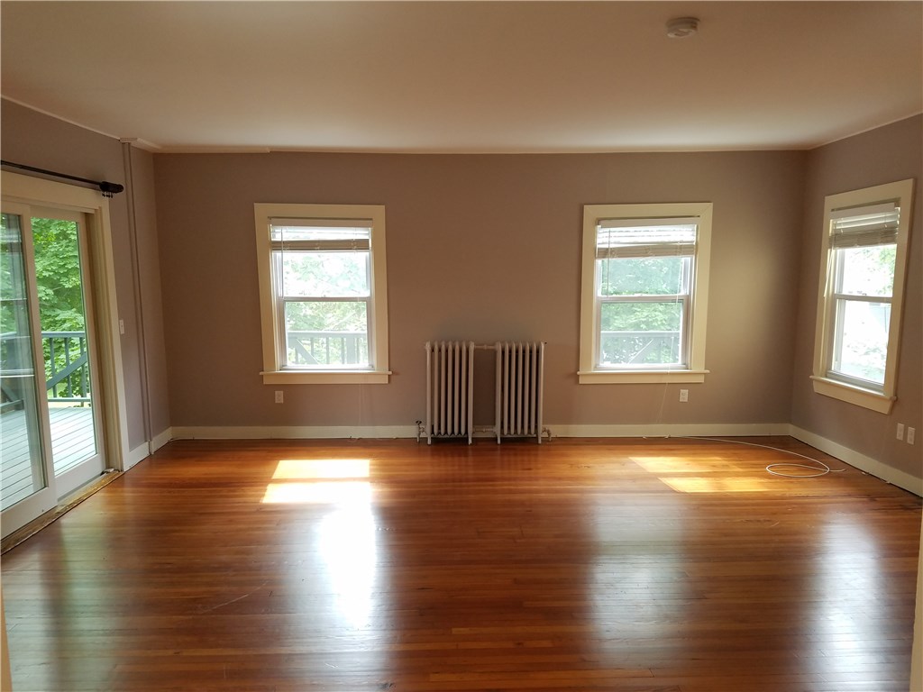 49 Merton Road, Unit 2 Newport, RI 02840 - Photo 14 of 42 Living Room/Dining Area & sliders to wrap around porch
