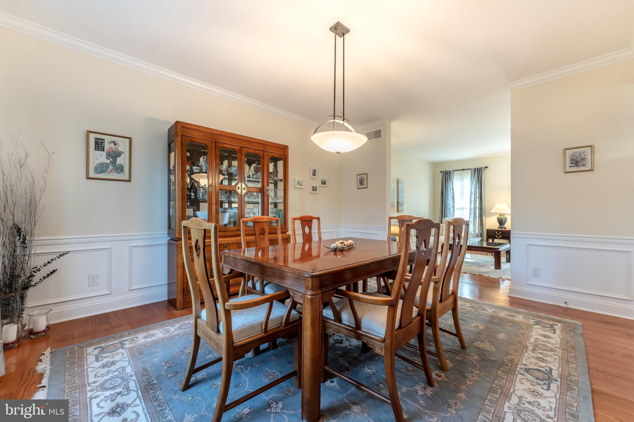 3505 Woodbyne Road Hellertown, PA 18055 - Photo 13 of 78 a view of a dining room and livingroom with furniture wooden floor a rug and a chandelier