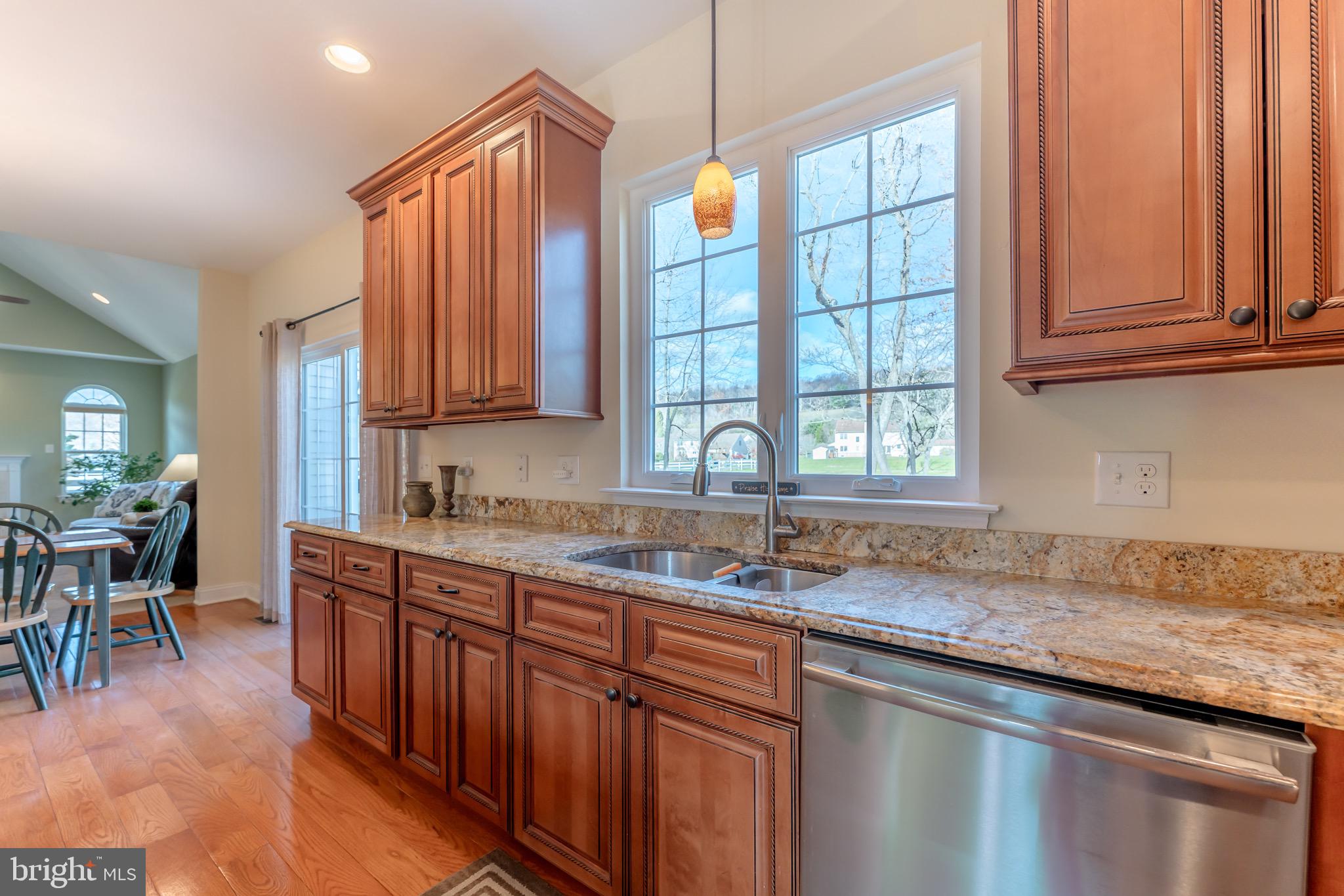3505 Woodbyne Road Hellertown, PA 18055 - Photo 16 of 78 a kitchen with stainless steel appliances granite countertop wooden cabinets a sink and dishwasher a stove with wooden floors