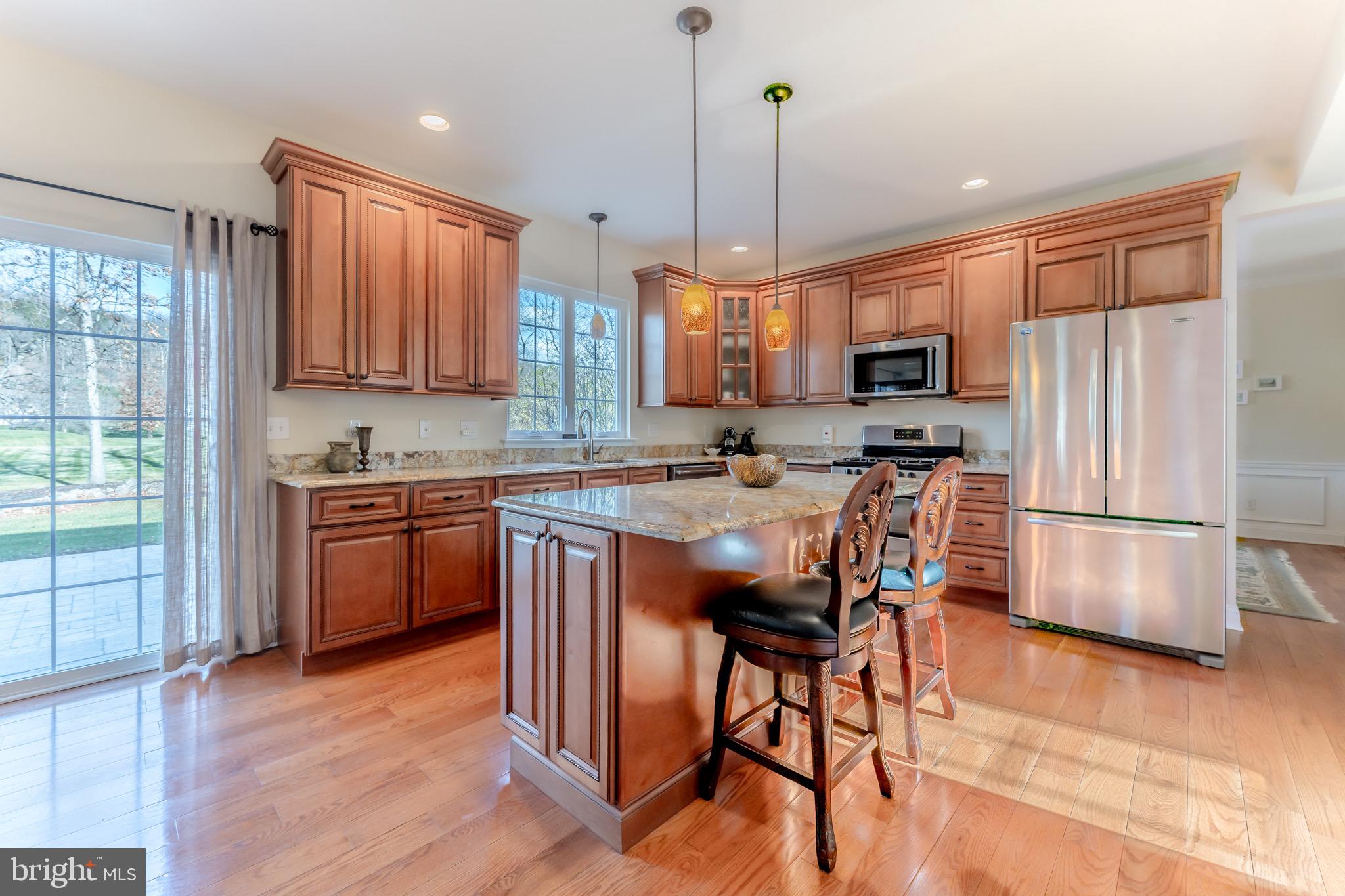 3505 Woodbyne Road Hellertown, PA 18055 - Photo 19 of 78 a kitchen with stainless steel appliances a stove a refrigerator a sink a stove a dining table and chairs