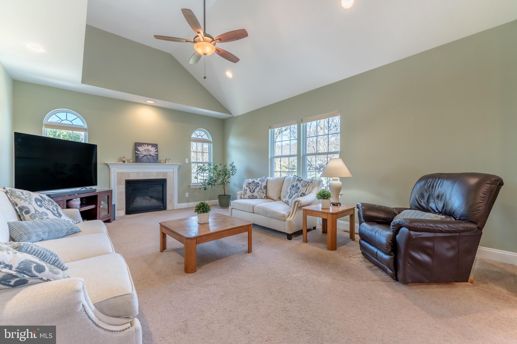 3505 Woodbyne Road Hellertown, PA 18055 - Photo 21 of 78 a living room with furniture a fireplace and a flat screen tv