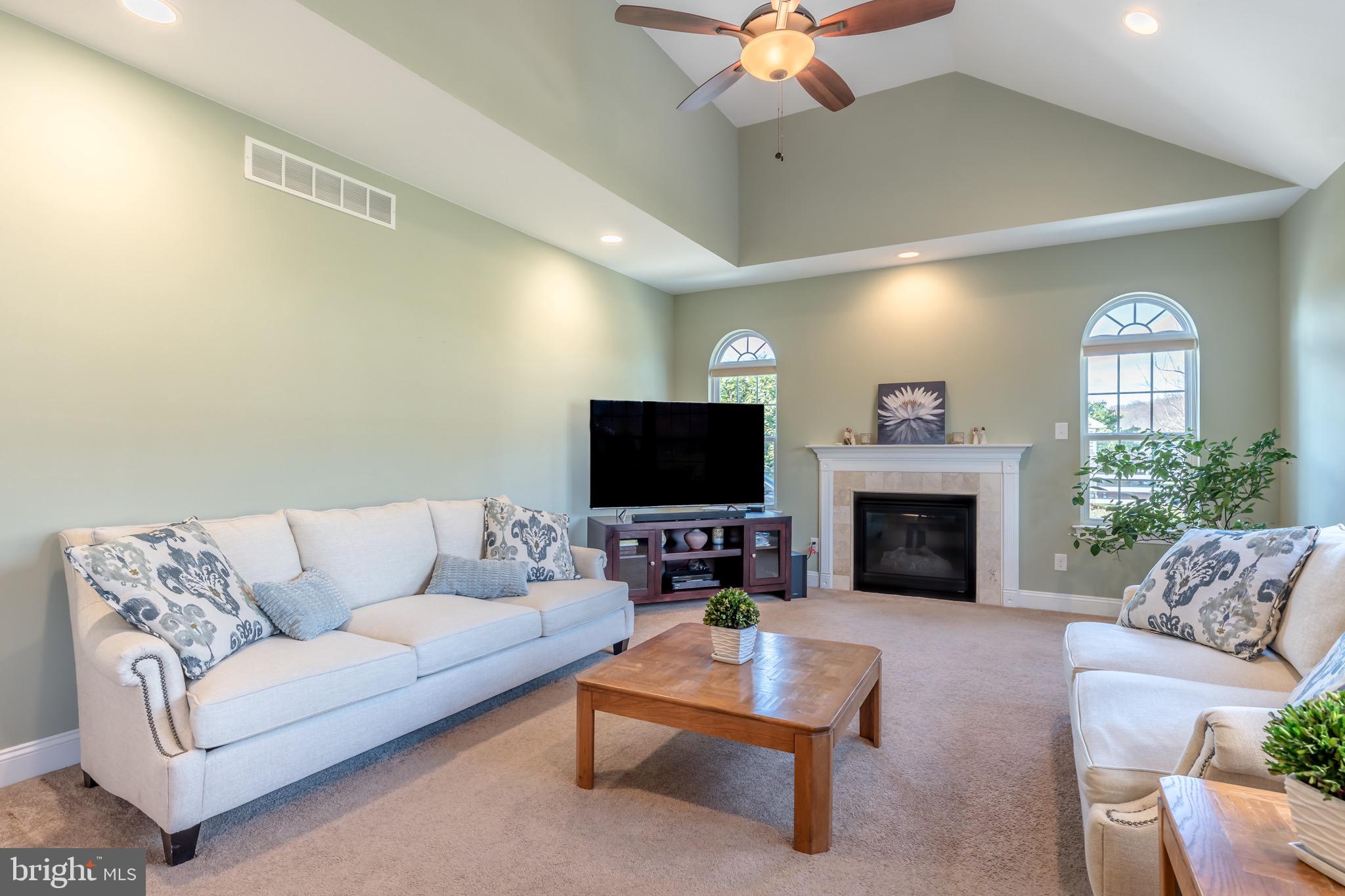 3505 Woodbyne Road Hellertown, PA 18055 - Photo 22 of 78 a living room with furniture a fireplace and a flat screen tv