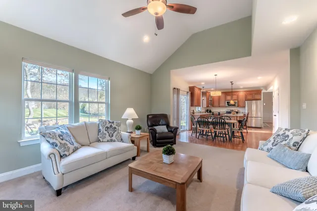 a spacious bedroom with a bed and a chandelier