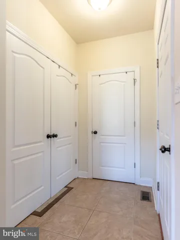 a bathroom with a granite countertop sink a mirror and a bathtub