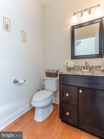 a bathroom with a granite countertop sink vanity mirror bathtub shower and a toilet