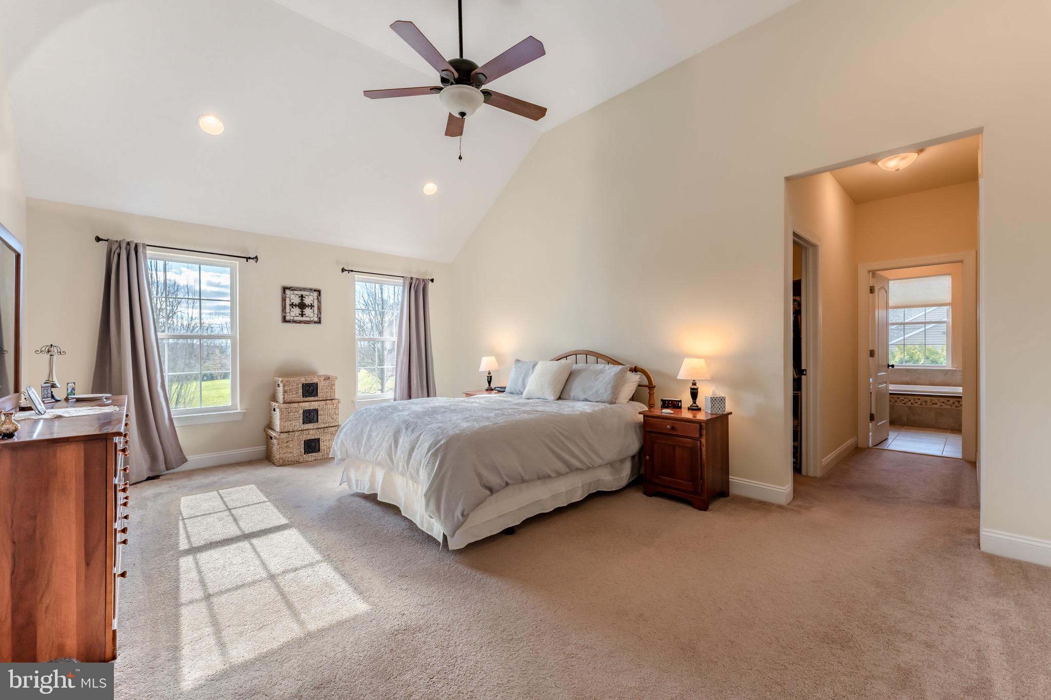3505 Woodbyne Road Hellertown, PA 18055 - Photo 35 of 78 a spacious bedroom with a bed and a chandelier