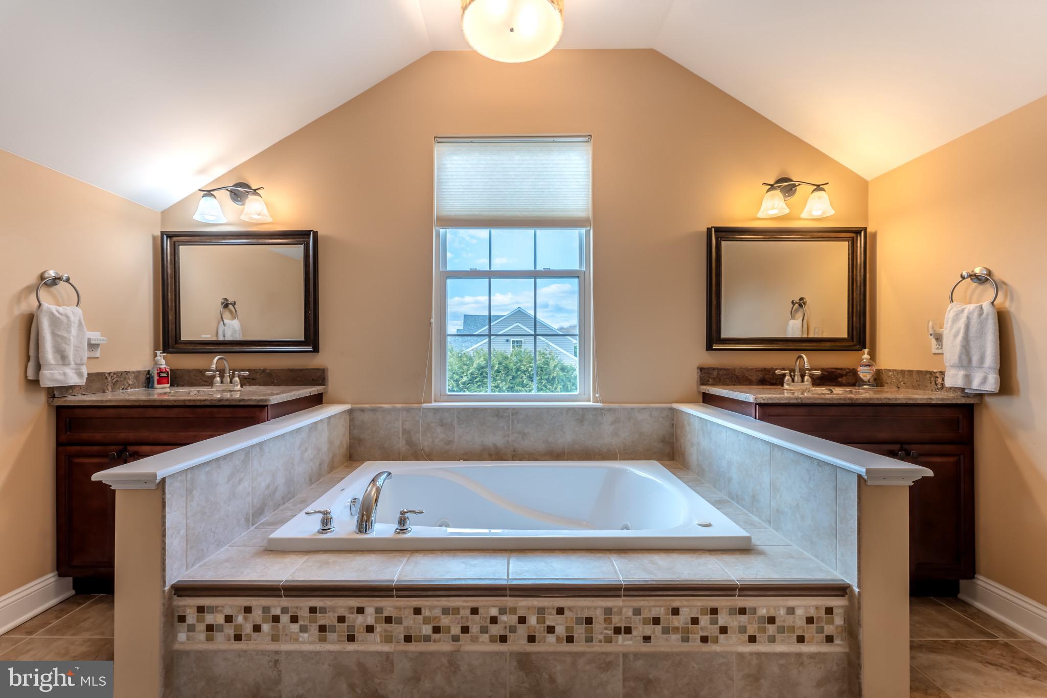 3505 Woodbyne Road Hellertown, PA 18055 - Photo 37 of 78 a bathroom with a granite countertop sink a mirror and a bathtub