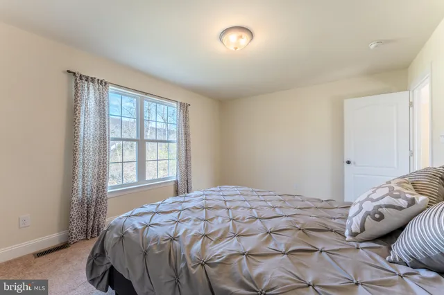 a view of a street with a building and a street sign