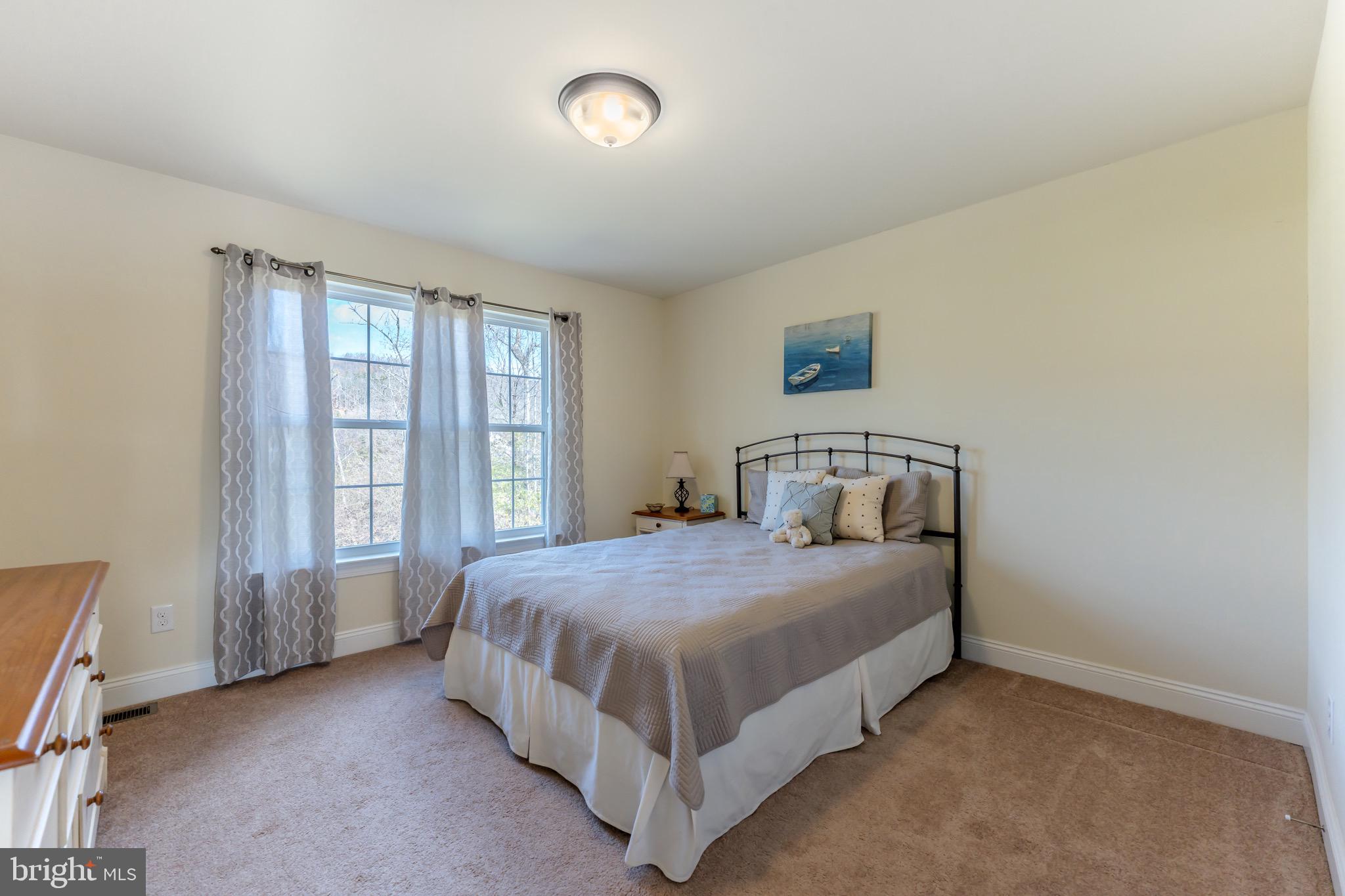 3505 Woodbyne Road Hellertown, PA 18055 - Photo 45 of 78 a bed sitting in a spacious bedroom next to a window