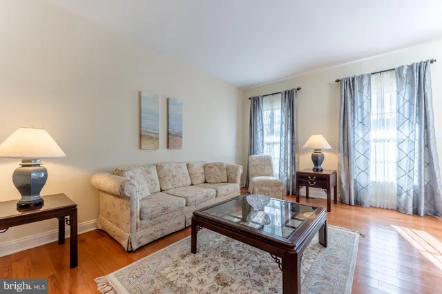 a dining room with furniture window and wooden floor