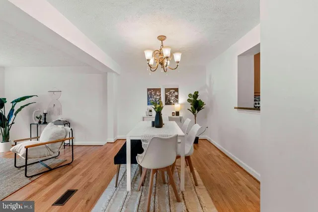 a view of a dining room with furniture wooden floor and chandelier