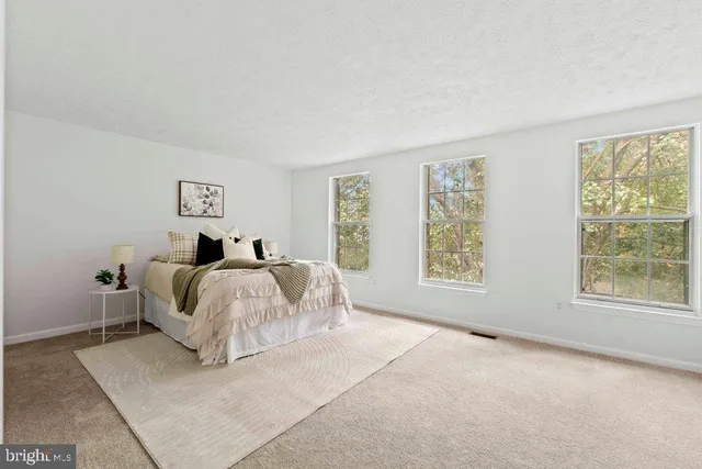 a bed room with a bed and a large window