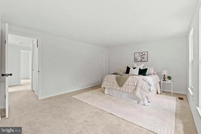 a bedroom with a white bed and a white floor