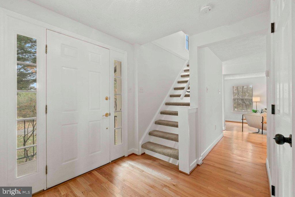 25 Capps Court Gaithersburg, MD 20878 - Photo 28 of 39 a view of a hallway with wooden floor and stairs