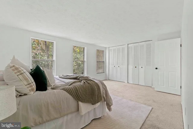 a spacious bedroom with two beds and a window