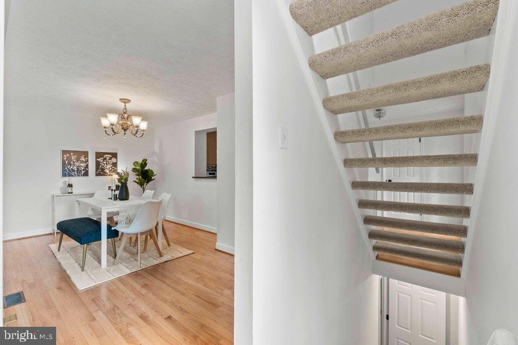 25 Capps Court Gaithersburg, MD 20878 - Photo 30 of 39 a view of a dining room with furniture and wooden floor