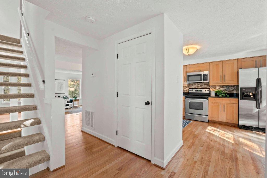 25 Capps Court Gaithersburg, MD 20878 - Photo 3 of 39 a view of a kitchen with a refrigerator a stove top oven and cabinets