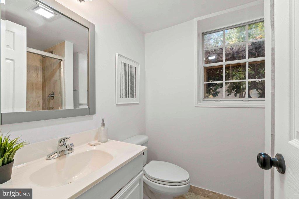 25 Capps Court Gaithersburg, MD 20878 - Photo 31 of 39 a bathroom with a toilet a sink a mirror and a window