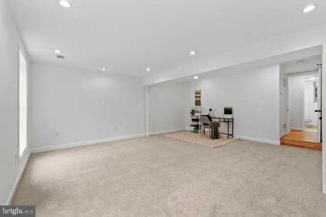 an empty room with furniture and a ceiling fan