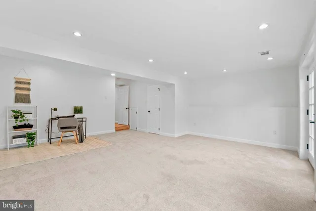 an empty room with furniture and window