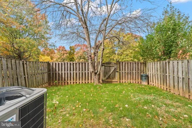 a view of a backyard with wooden fence