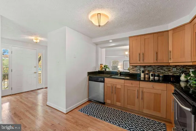 a kitchen with stainless steel appliances granite countertop a sink and cabinets