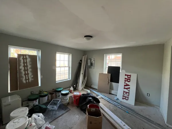 a living room with furniture a window and a flat screen tv