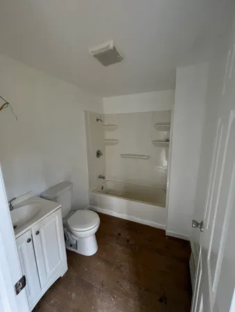 a bathroom with a toilet and a shower