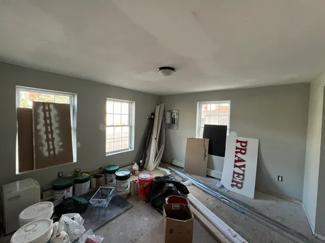 a living room with furniture a window and a flat screen tv