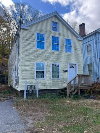 a view of a house with a yard and deck