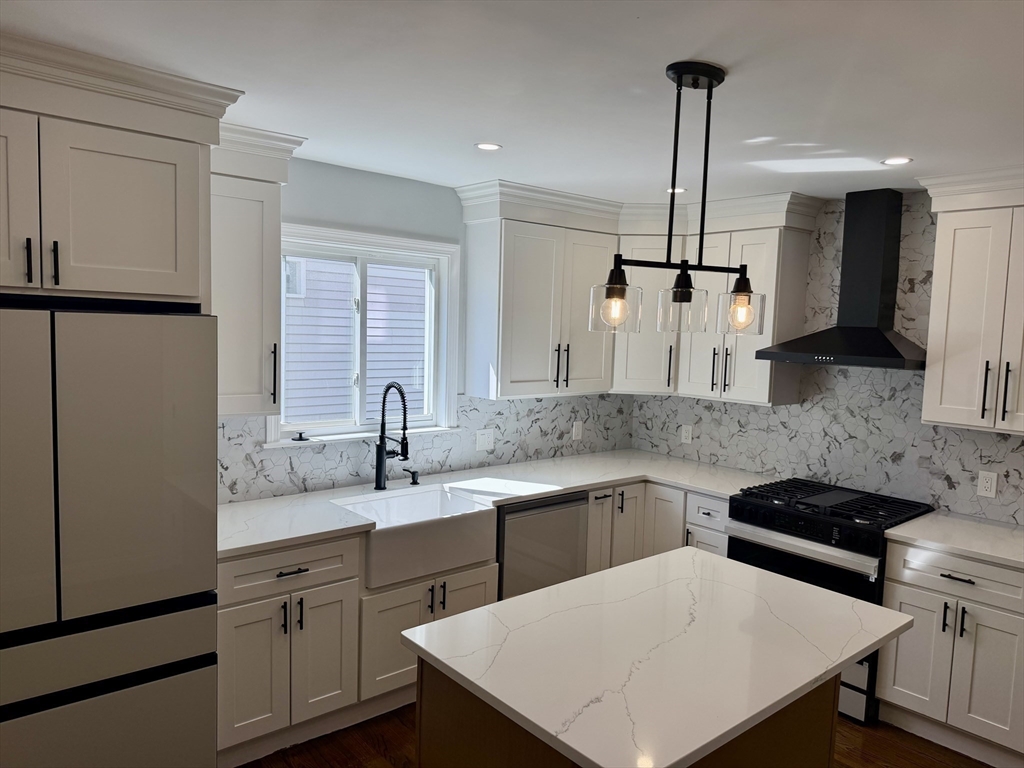 a kitchen with stainless steel appliances a sink stove and refrigerator