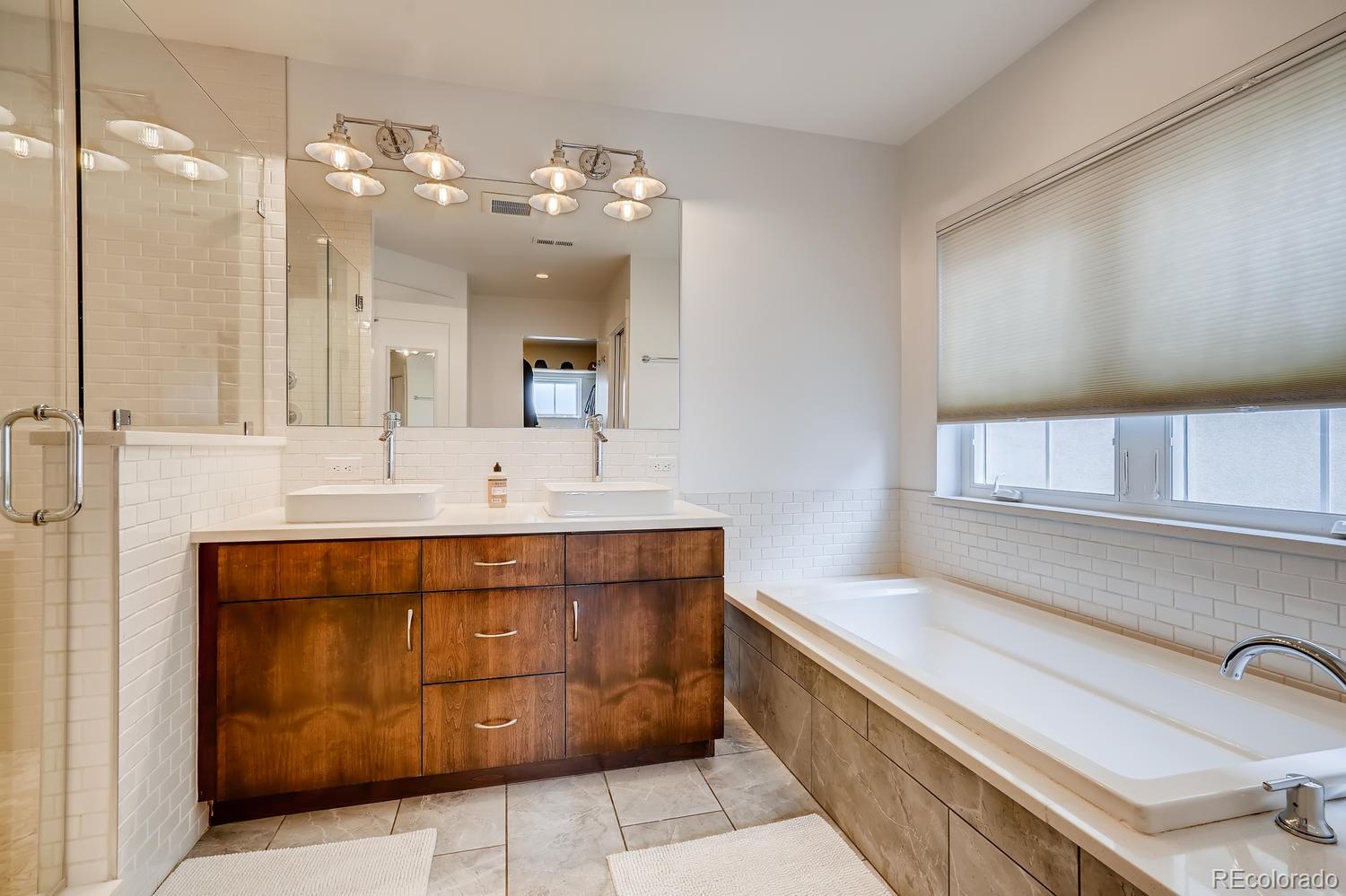 4565 Stuart Street Denver, CO 80212 - Photo 15 of 28 a spacious bathroom with a sink a vanity and a mirror