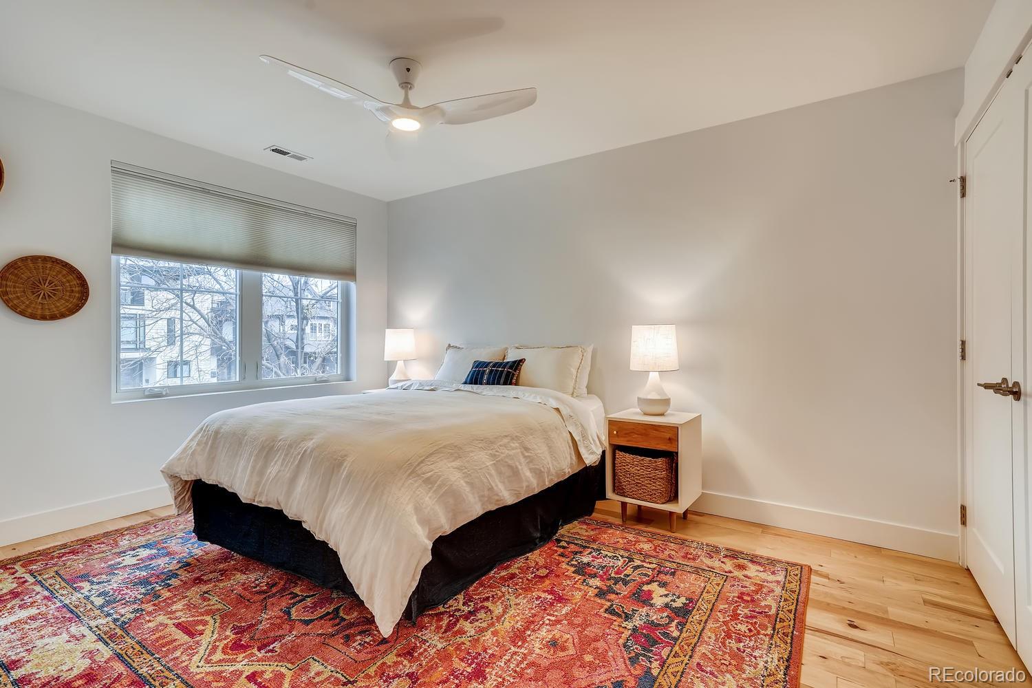 4565 Stuart Street Denver, CO 80212 - Photo 17 of 28 a bedroom with a large bed and a window