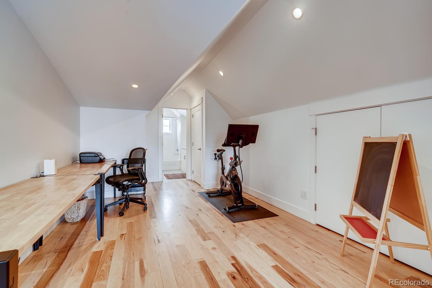4565 Stuart Street Denver, CO 80212 - Photo 19 of 28 a view of a room with gym equipment and wooden floor
