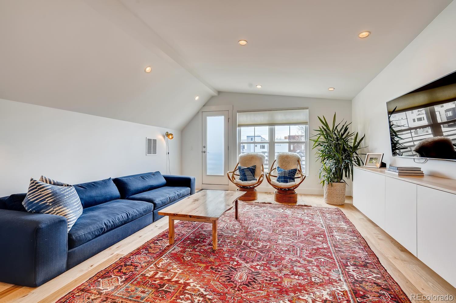 4565 Stuart Street Denver, CO 80212 - Photo 20 of 28 a living room with furniture a rug and a large window