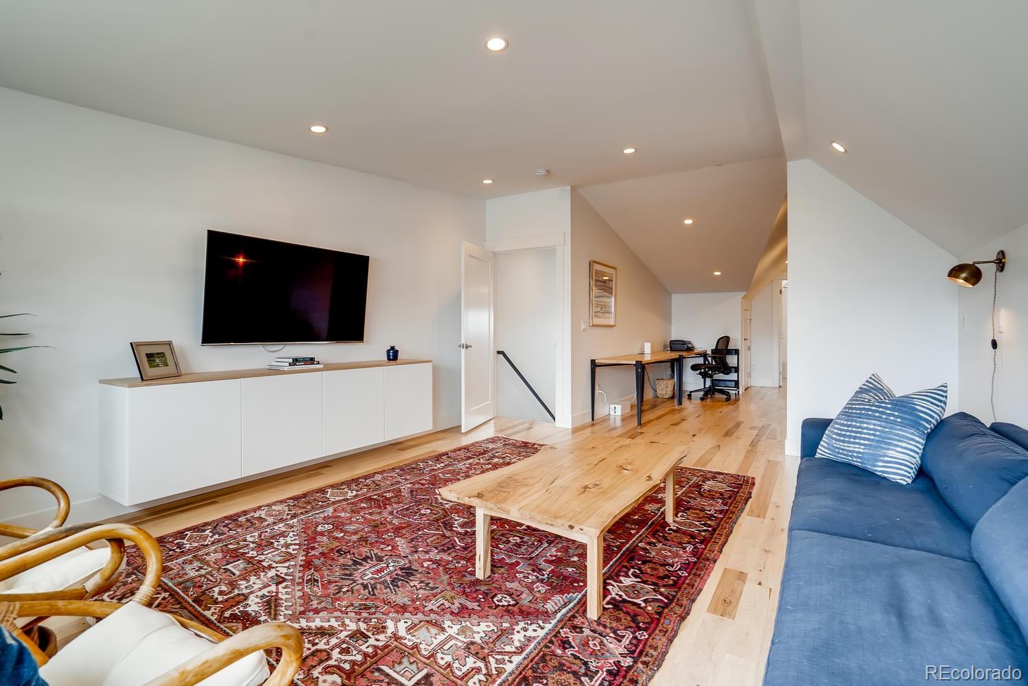 4565 Stuart Street Denver, CO 80212 - Photo 21 of 28 a living room with furniture and a flat screen tv