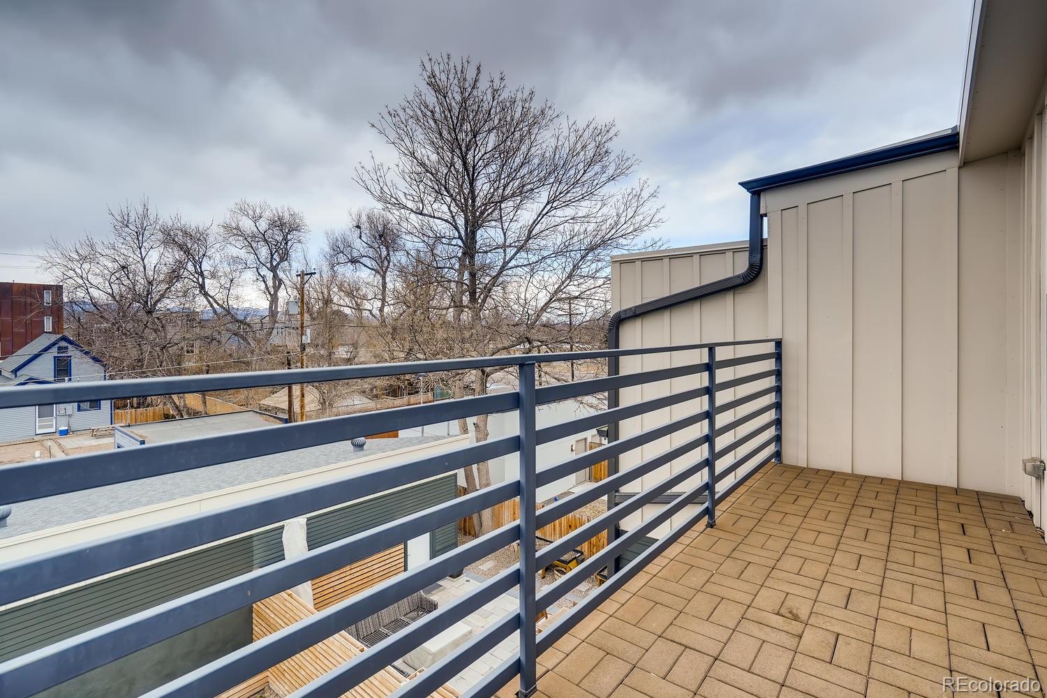 4565 Stuart Street Denver, CO 80212 - Photo 23 of 28 a view of a balcony with wooden floor and fence