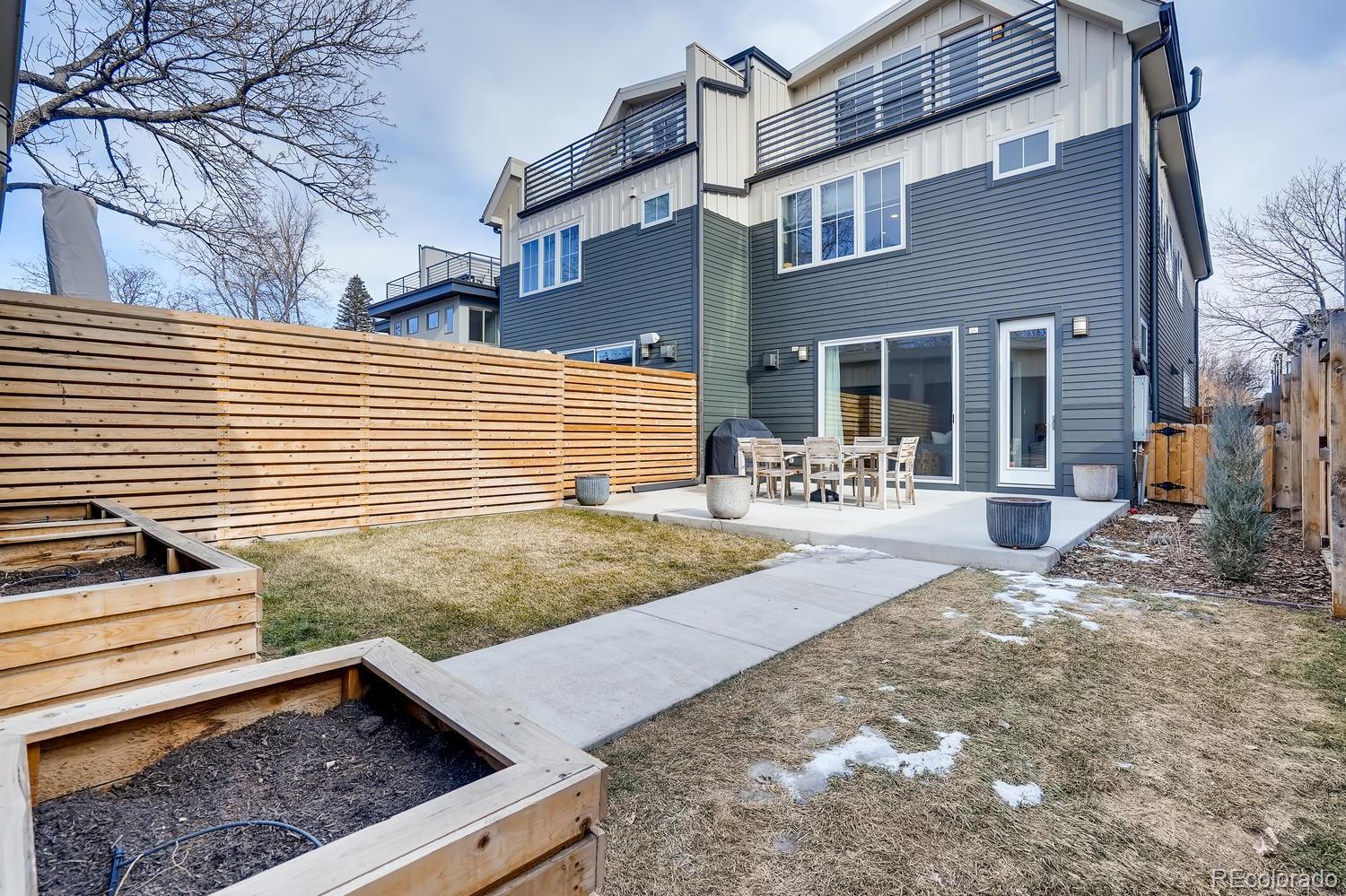 4565 Stuart Street Denver, CO 80212 - Photo 25 of 28 a view of a backyard with chairs and a tree