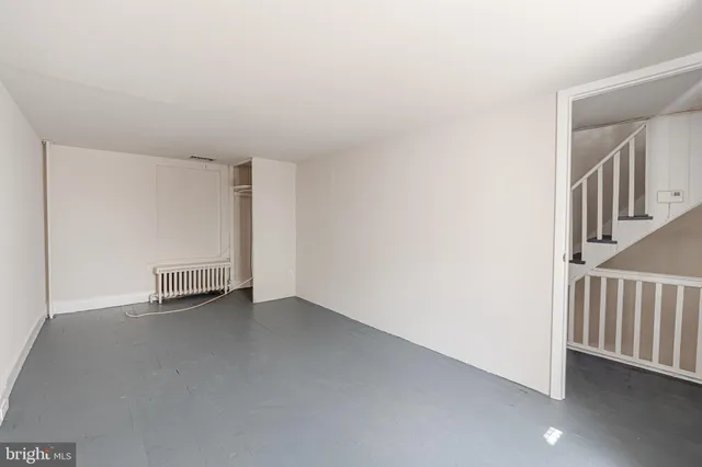 a view of an empty room with stairs