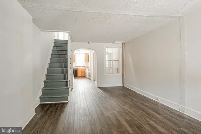a view of entryway with stairs and wooden floor