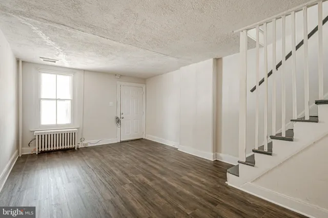 a view of an room with wooden floor and windows