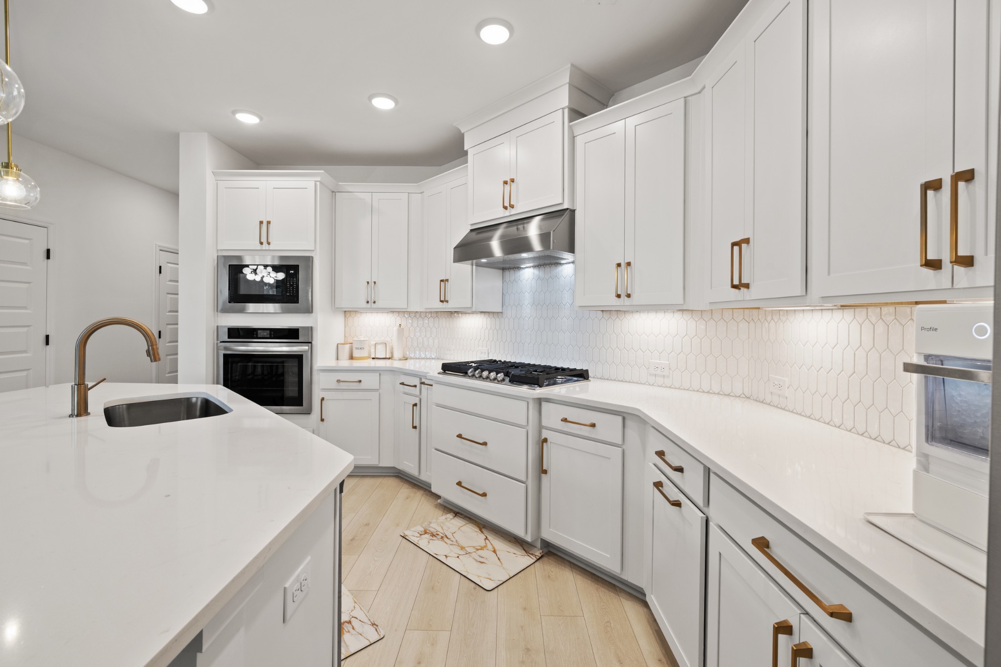 2104 Mackinac Bend Gallatin, TN 37066 - Photo 15 of 23 a kitchen with kitchen island granite countertop white cabinets and white appliances