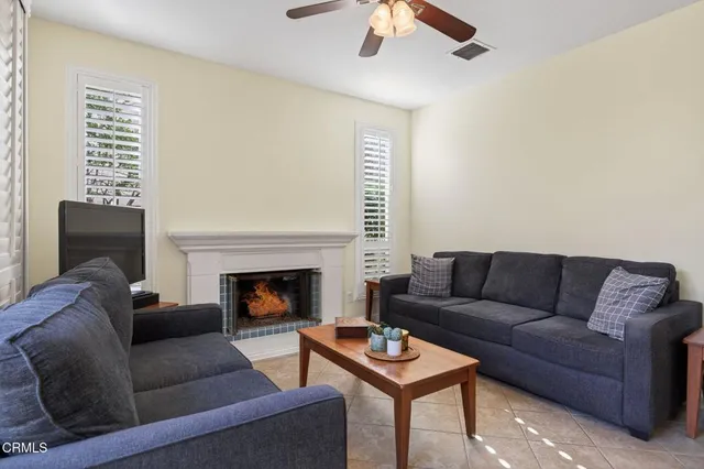 a bedroom with a bed and large windows